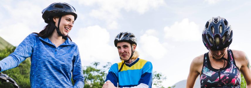 Friends cycling together in Scotland