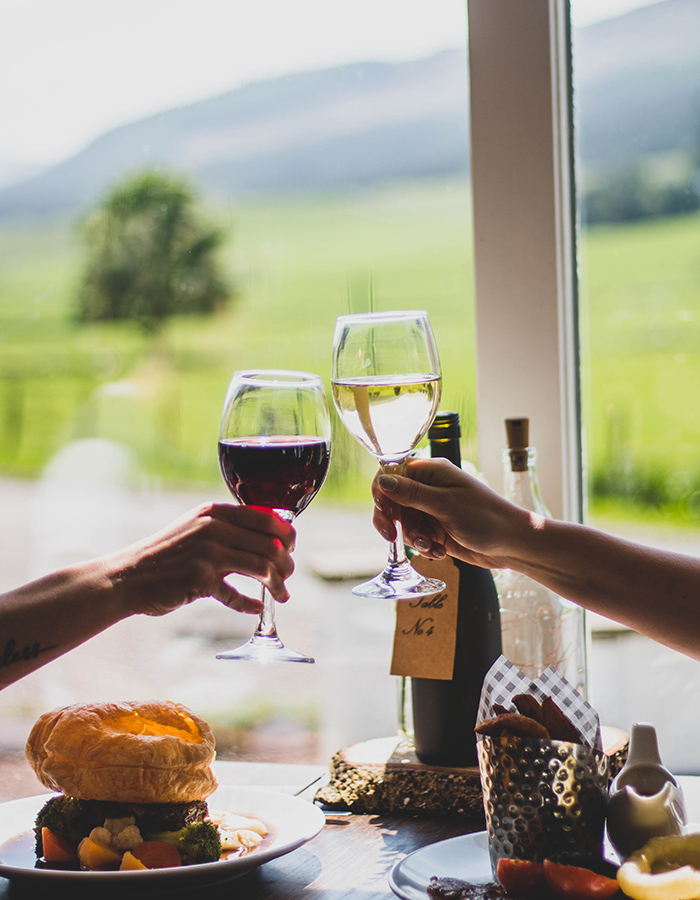 People dining at Glen Clova Hotel with stunning views in the background of the glen