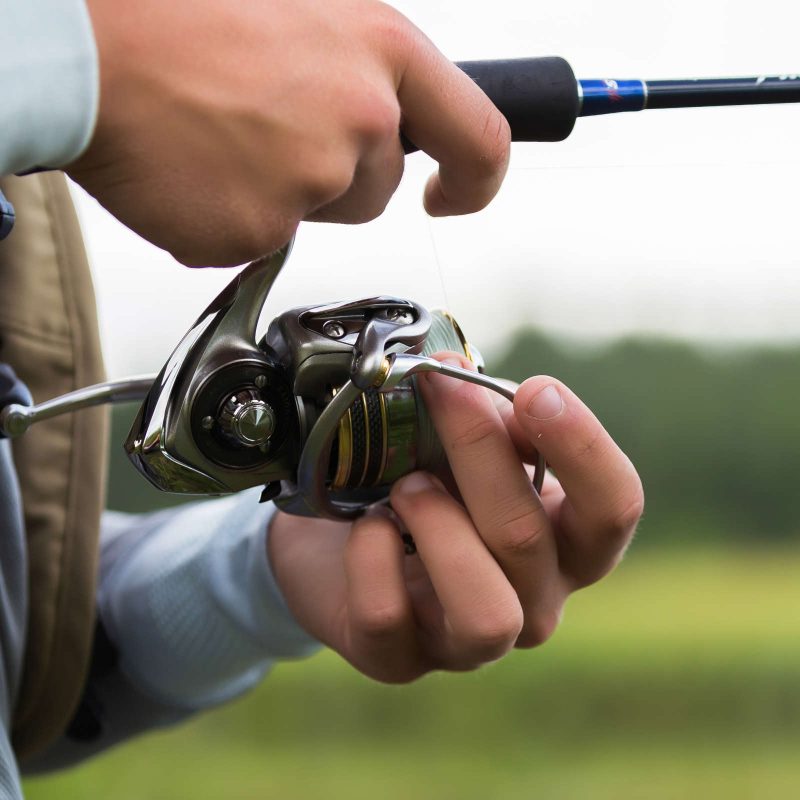 Close up of hands on fishing rod