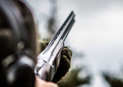 Shooter aiming at a clay pigeon