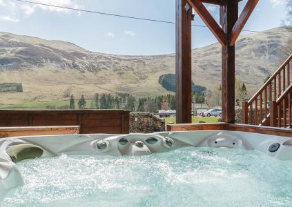 A hot tub with a stunning view on a Glen Lodge at Glen Clova Hotel and Lodges in Scotland