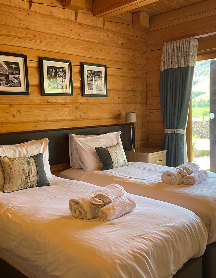 A cosy double bedroom in a Glen Lodge at Glen Clova Hotel and Lodges in Scotland