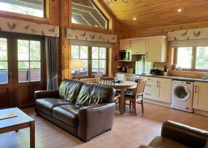 Cosy open plan living, kitchen, dining and sitting room in a Hideaway Lodge at Glen Clova Hotel and Lodges in Scotland