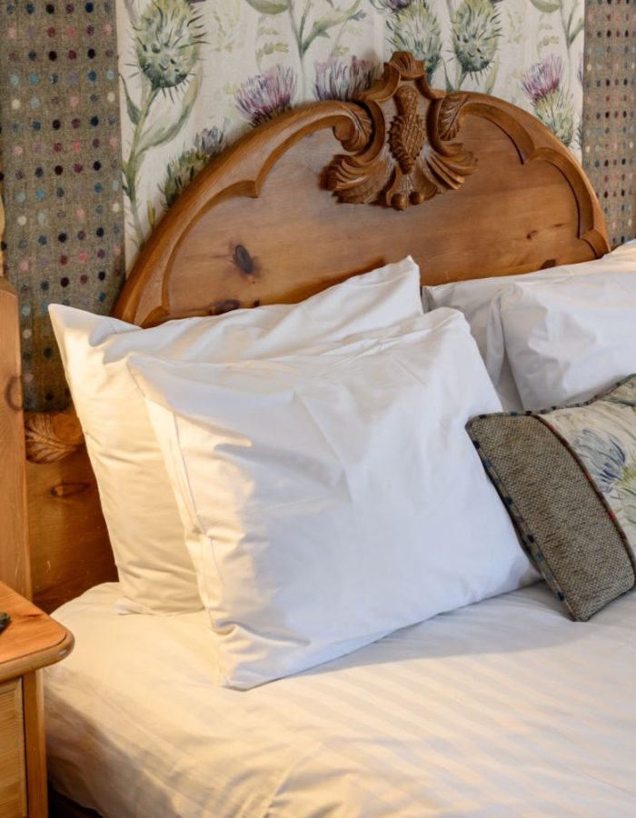 Close up of bed in four poster room