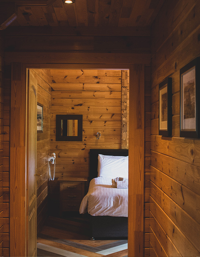 A bedroom in a Clova Lodge at Glen Clova Hotel