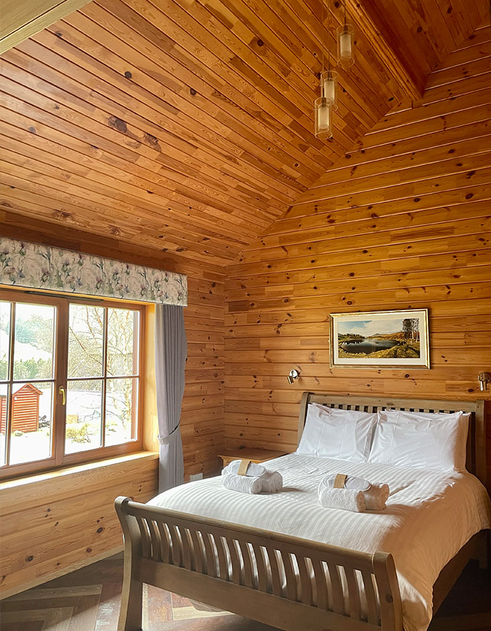 A double bedroom in a Clova Lodge at Glen Clova Hotel