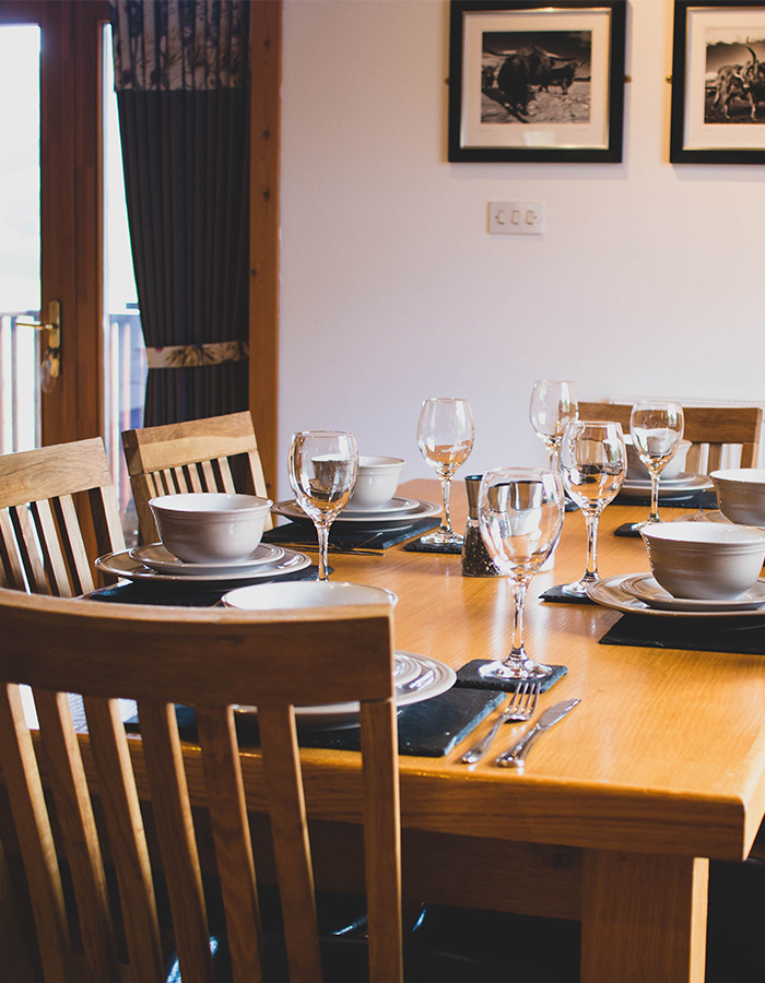 A dining table set for dining in a Glen Lodge at Glen Clova Hotel