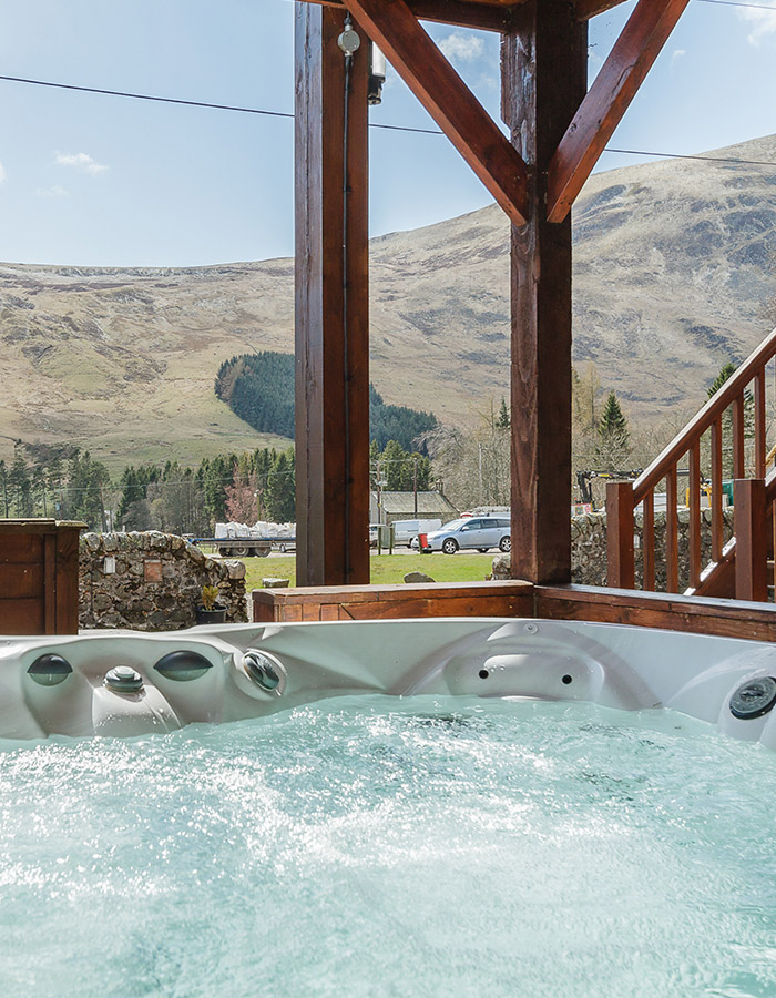 A. hot tub with spectacular view at a Glen Lodge at Glen Clova Hotel