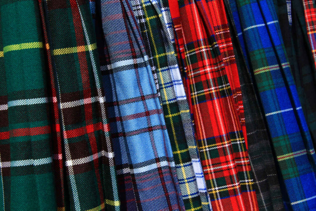 A selection of tartan kilts in different colours and patterns