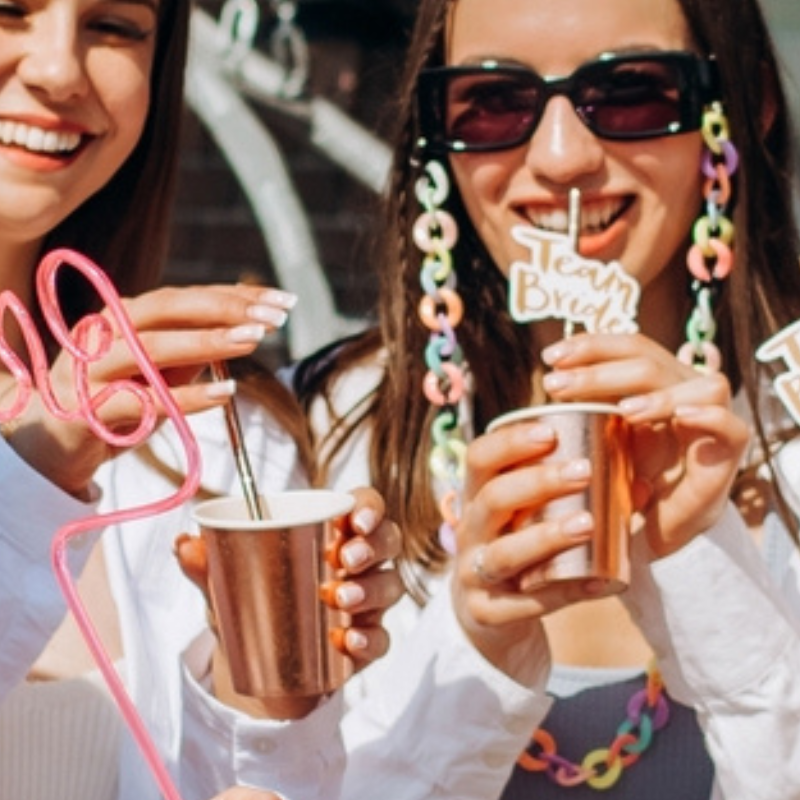 Happy and cheerful group of women friends together dancing and drink champagne on the rooftop at home. hen party.