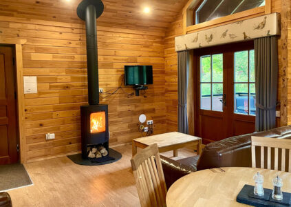 The Hideaway Lodge living room with log burning fire.