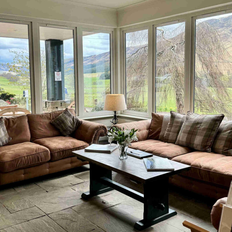 Hotel lobby with large windows overlooking the hills