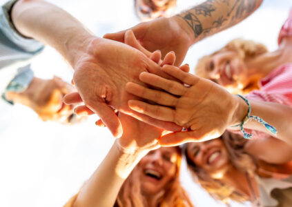 Group in a circle with hands together