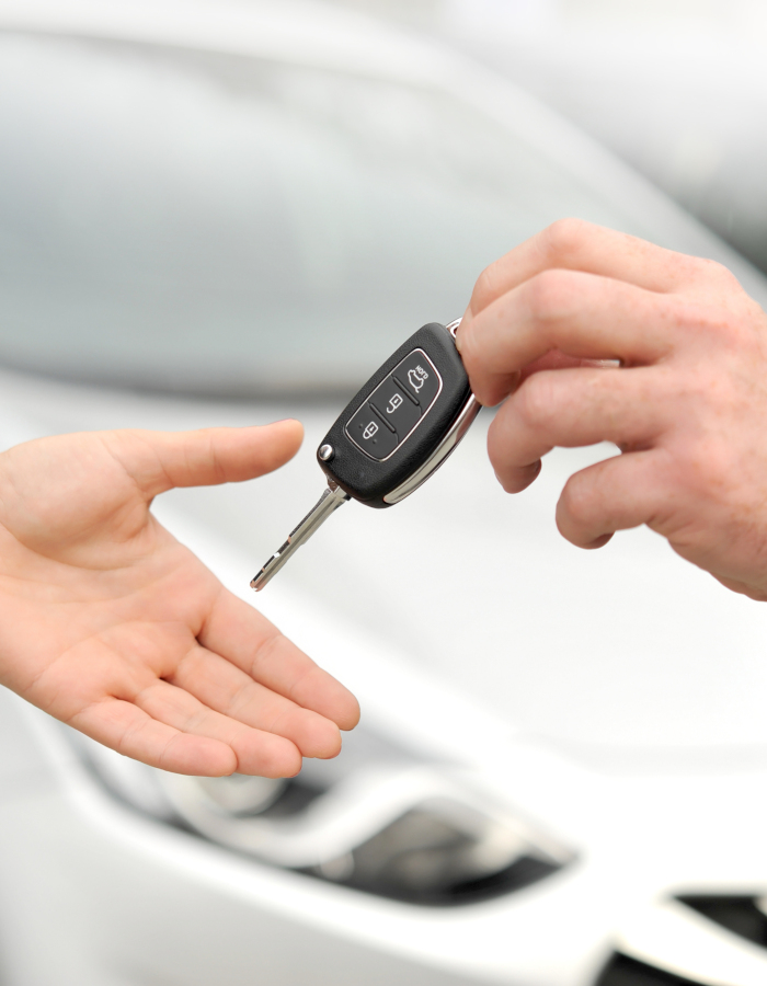 Car key being handed over to a customer