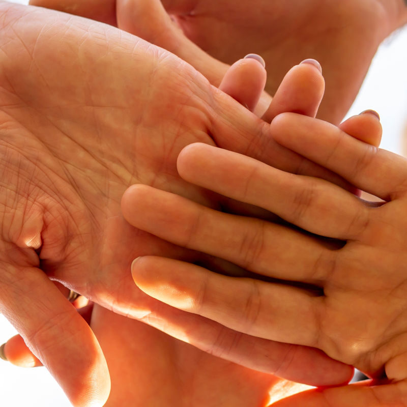 Group in a circle with hands together