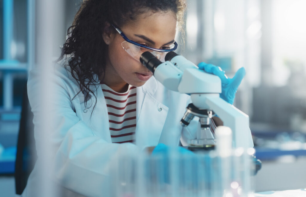 Scientist looking into a microscope